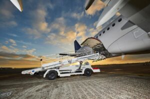 Belt loader docked on Airbus narrow-body airplane