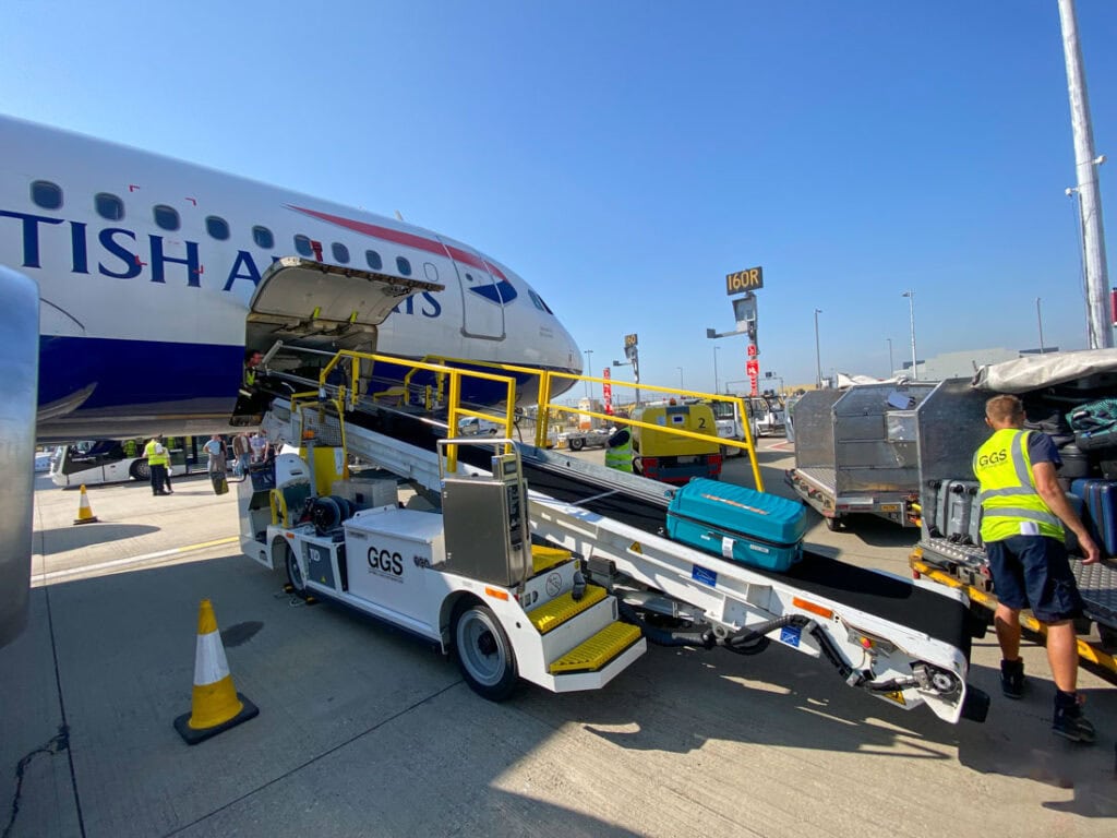 Power Stow Rollertrack Conveyor operated by Gatwick Ground Services loading baggage for a British Airways aircraft at London Gatwick Airport.
