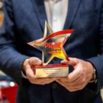 Close-up of Martin Vestergaard holding the Pride of Ground Handling Awards 2025 lifetime achievement trophy, with the star-shaped award clearly visible.
