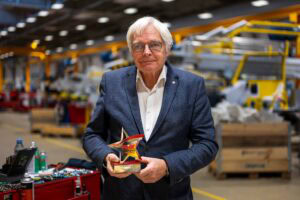 Martin Vestergaard, founder of Power Stow, standing and holding his Pride of Ground Handling Awards 2025 trophy, recognising his lifetime achievement.